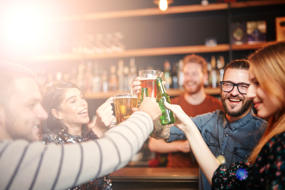 Friends drinking booze at a pub in Scotland late at night